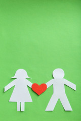 Paper people together in love on the green background