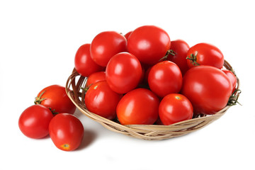 Fresh red tomatoes in basket isolated on white