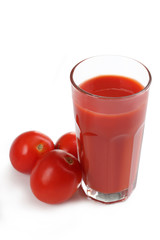 Fresh red tomatoes and tomato juice in glass isolated on white