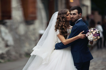 Happy couple of newlyweds valentynes posing and hugging in old e