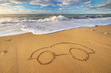 Draw car on beach sand.