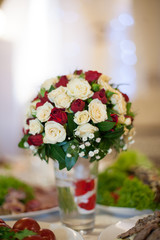 Closeup of elegant freshly cut wedding bouquet with white and re