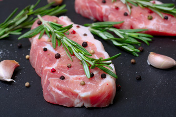 fresh raw meat with rosemary and pepper