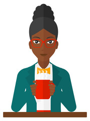 Woman sitting with cup of coffee.