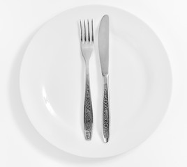 plate with fork and knife  isolated on a white