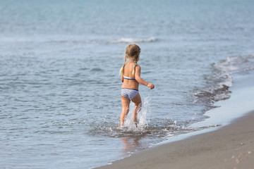 Girl runs along the beach