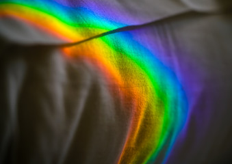 Rainbow on my pillow. The full range of colors of a rainbow reflected on my pillow.