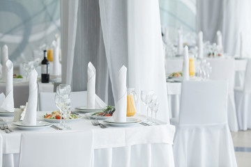 White restaurant interior. Table layout.