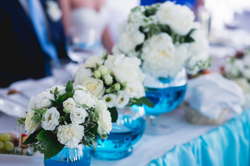 Beautiful wedding interior and table decor, flower decoration with flowers bouquet, with roses, tulips, peonies