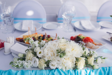 Beautiful wedding interior and table decor, flower decoration with flowers bouquet, with roses, tulips, peonies