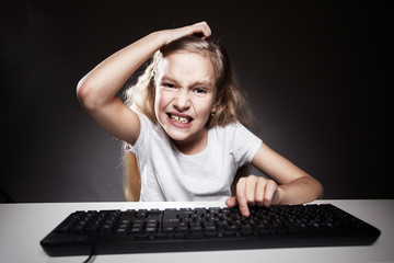 Girl looks with disappointment to computer