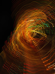 Multicoloured warm lights forming radial starburst light trails