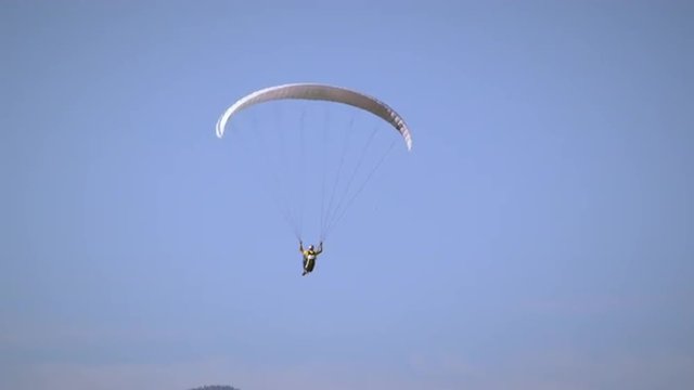 Paraglider is soaring through the air, soon joined by hang glider.