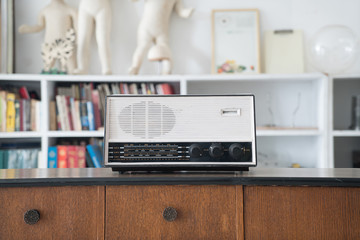 radio on wooden table and bookshelf background