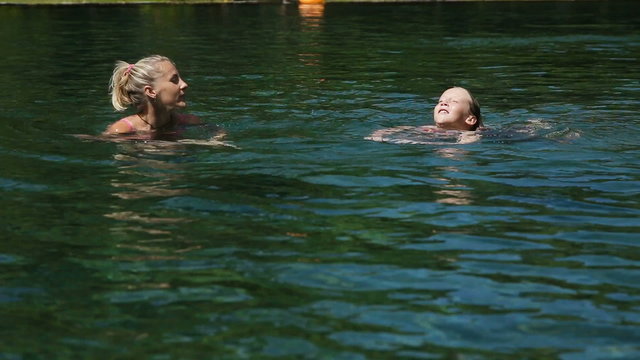 Happy family in the swimming pool