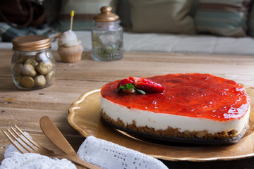 Heart shaped cheesecake with raspberry jelly on a gold plate