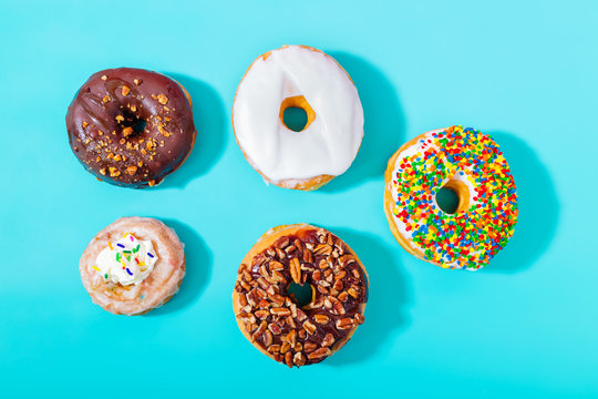 Assorted Donuts On Pastel Blue Background