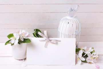 Background  with tender apple blossom, candle in decorative bird
