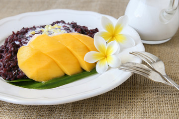 Homemade coconut black sticky rice with mango, selective focus