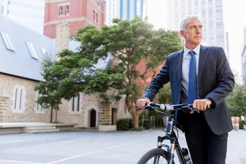 Successful businessman riding bicycle