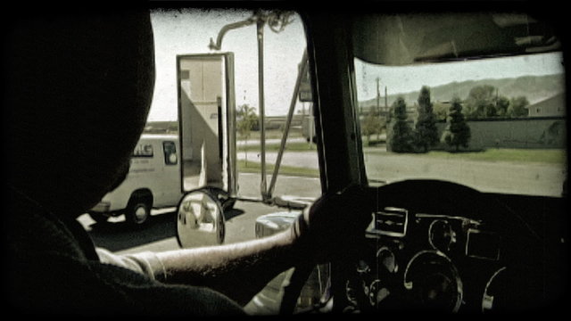 Truck driver backs up truck. Vintage stylized video clip.