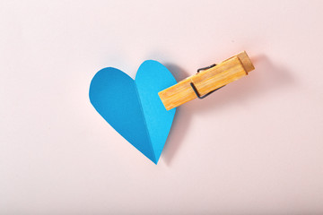 Blue paper heart on pink paper