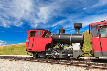 Steam train in a beautiful alpine landscape.