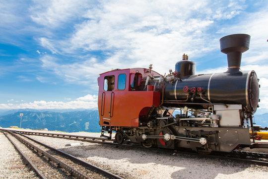 Steam train in a beautiful alpine landscape.