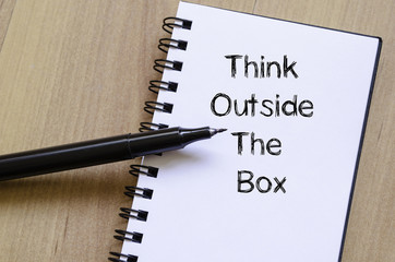 Think outside the box write on notebook