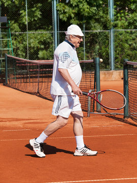 Portrait of active senior playing tennis