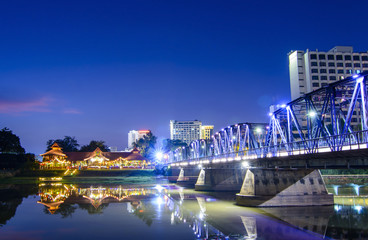 Iron bridge At twilight time Chiangmai in Thailand , With Lens F