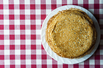 Stack of pancakes on white plate