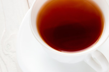 strong tea in a white cup closeup