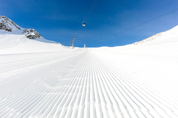 Newly groomed ski slope on a sunny day