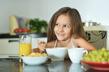 Beautiful little girl with breakfast