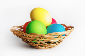 Fototapeta na wymiar Colorful easter eggs in a wicker basket.