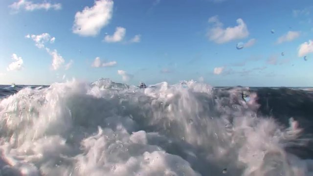 Boiling water on background of blue sky and clouds.  Amazing, beautiful underwater world Bahamas and the life of its inhabitants, creatures and diving, travels with them. 