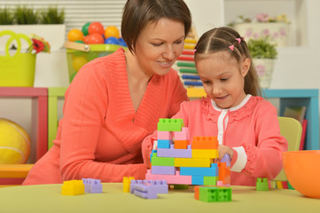 little girl playing with mother