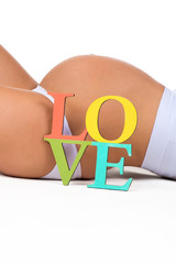 Pregnant belly with a sign Love. Concept of pregnancy and love pregnant woman to child
