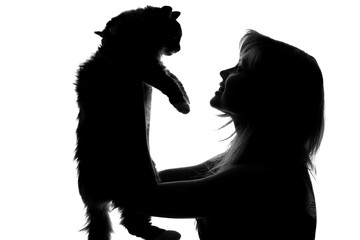 silhouette of a woman with a cat 