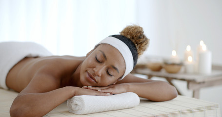 Happy african american girl relaxing in luxury spa salon
