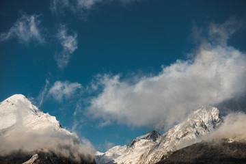 Fototapeta na wymiar High mountain peak and blue sky, winter landscape