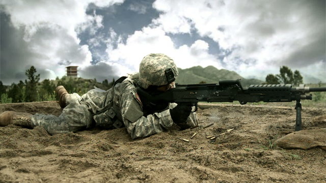 Super slow motion shot of soldier shooting M240 Machine Gun.