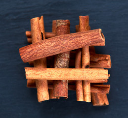 Cinnamon sticks and anice on blue stone background. selected focus