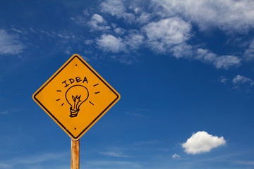 drawing of Idea icon on yellow traffic sign