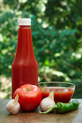 Tomato, garlic, hot pepper, bottle of ketchup and juice