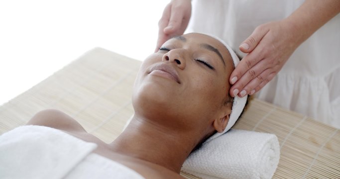 Portrait of young beautiful african american woman in spa environment slow motion