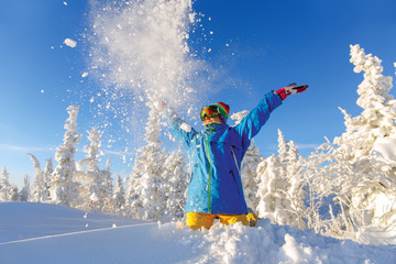 Woman snowboarder having fun in a fantastic winter forest