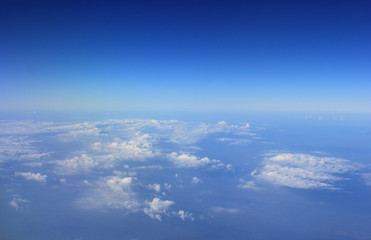 Fototapeta na wymiar Blue sky and Cloud Top view from looking through window aircraft