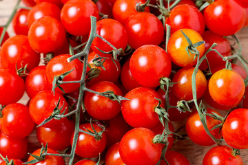 Fresh cherry tomatoes on wooden background